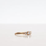 Mumbaistockholm Fine Jewelry Ring: Elise Ring in 18K yellow gold with five white, conflict-free diamonds. The center diamond is 0.25 CT, and on each side are two 0.11 CT diamonds, and two 0.04 CT diamonds. Pictured from the side.