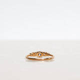 Mumbaistockholm Fine Jewelry Ring: Elise Ring in 18K yellow gold with five white, conflict-free diamonds. The center diamond is 0.25 CT, and on each side are two 0.11 CT diamonds, and two 0.04 CT diamonds. Pictured from the back.