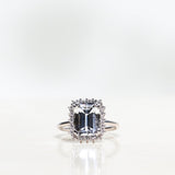 Solitaire Ring with White Topaz and Diamond Halo in White Gold